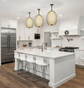 A modern kitchen with stylish pendant lights hanging above a kitchen island, providing both task and ambient lighting.