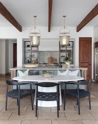 A modern pendant light hanging above a stylish kitchen island, illuminating the space with warm and inviting lighting.